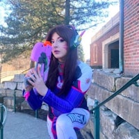 a woman in a cosplay holding a gun